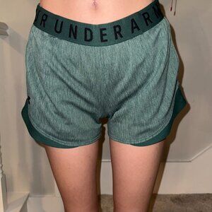 Green athletic wear shorts, Under Armour.
